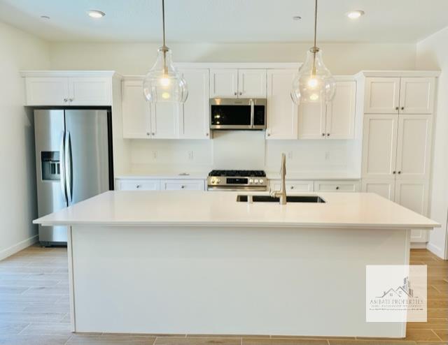334 Aria Avenue South Madera, CA 93636 - Photo 10 of 20 a kitchen with kitchen island granite countertop a sink a center island stainless steel appliances and cabinets