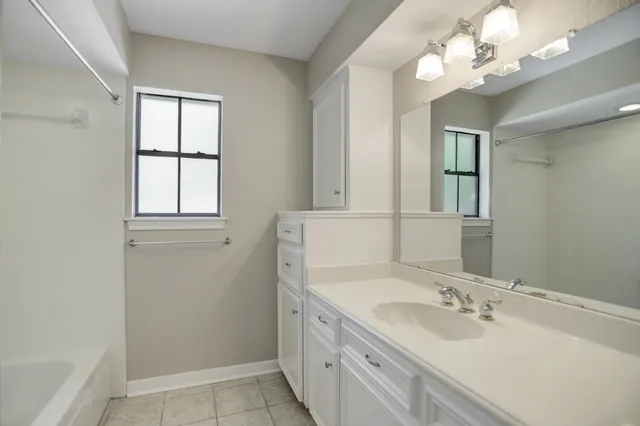 a bathroom with a double vanity sink and a mirror