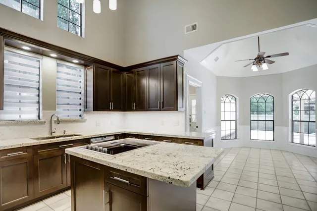 a kitchen with a sink stove and cabinets