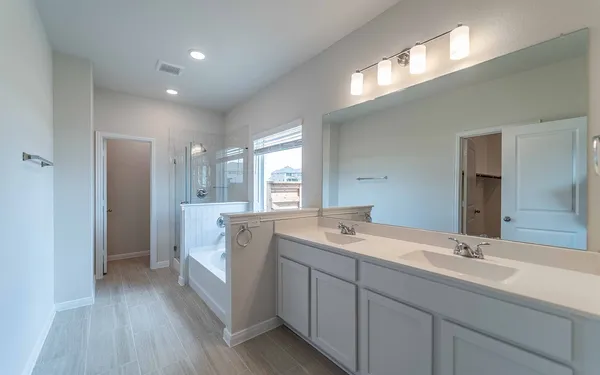 a bathroom with a double vanity sink and mirror