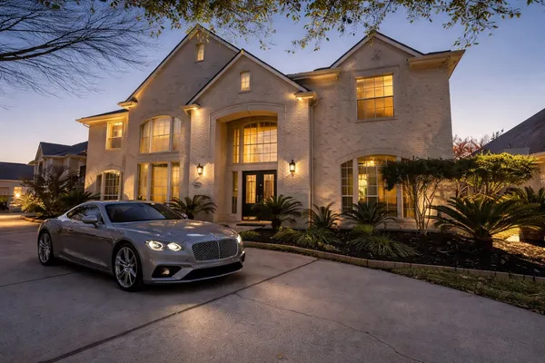 a car parked in front of white house