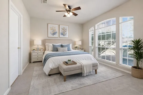 a bedroom with a bed and window