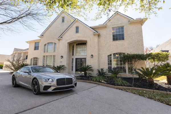 a view of staircase with a rug and a chandelier