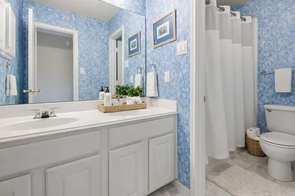 an aerial view of a house with a lake