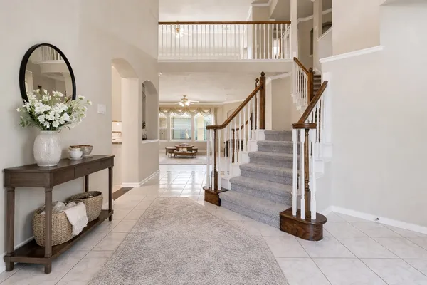 a living room with furniture and a large mirror