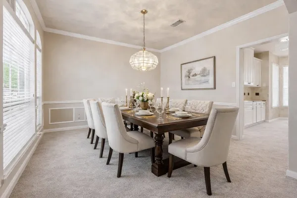 a view of a dining room with furniture wooden floor and chandelier