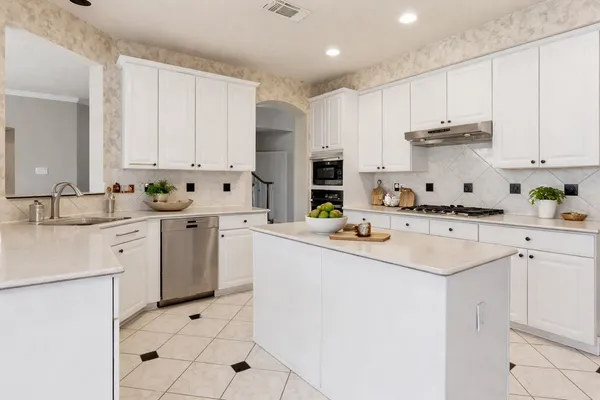a living room with furniture chandelier and fireplace