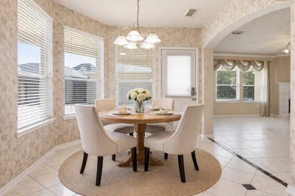 a en suite bathroom with a double vanity sink a mirror a window and a shower