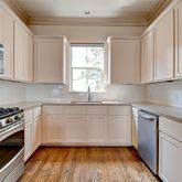 a kitchen with stainless steel appliances granite countertop a sink a stove a microwave and wooden cabinets