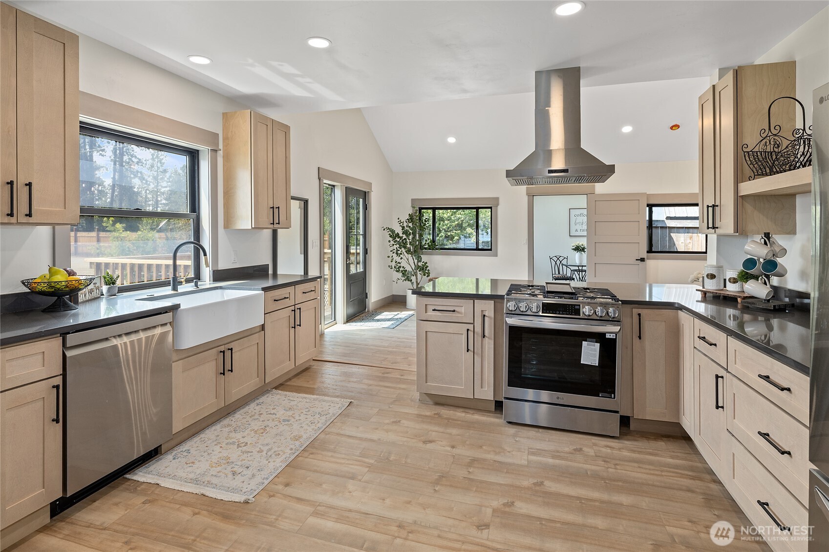 70 Gobblers Knob Road Cle Elum, WA 98922 - Photo 11 of 30 a large kitchen with stainless steel appliances granite countertop a stove a sink dishwasher a refrigerator and a dining table with wooden floor