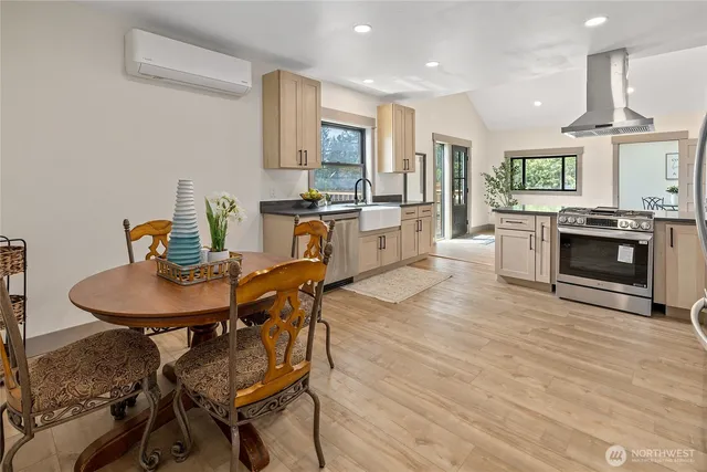 a kitchen with sink cabinets dining table and chairs