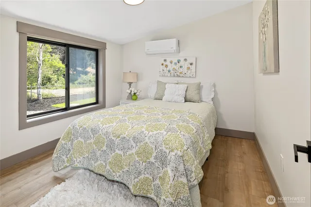 a large bed sitting in a bedroom next to a window