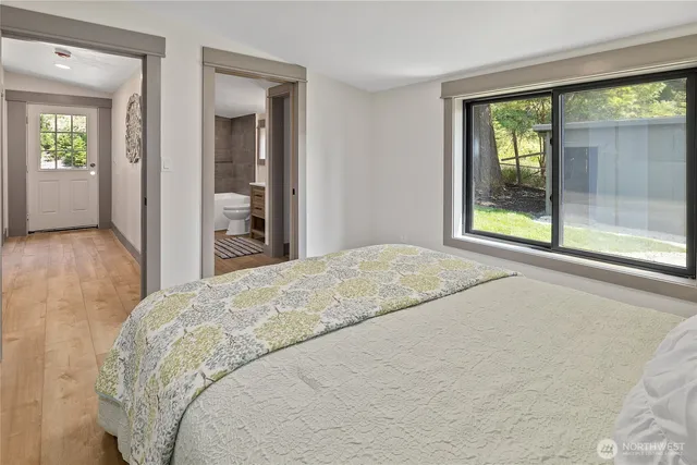 a bedroom with a bed and a large window