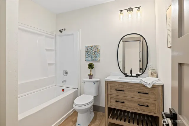 a bathroom with a sink a mirror a toilet and a bathtub