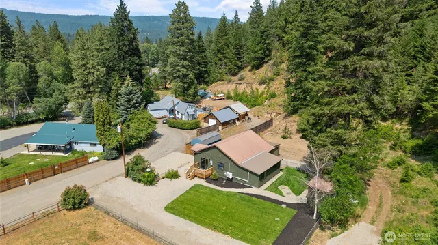 an aerial view of a house with yard swimming pool and outdoor seating