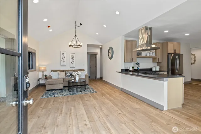 a living room with kitchen island furniture and a chandelier