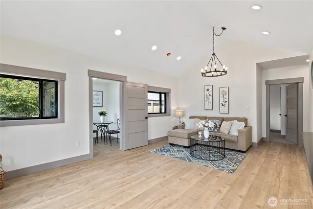 a living room with furniture and a chandelier