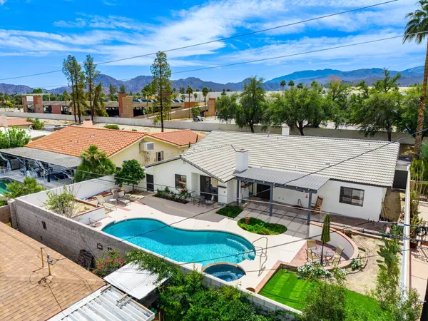 a aerial view of a house with swimming pool garden and patio
