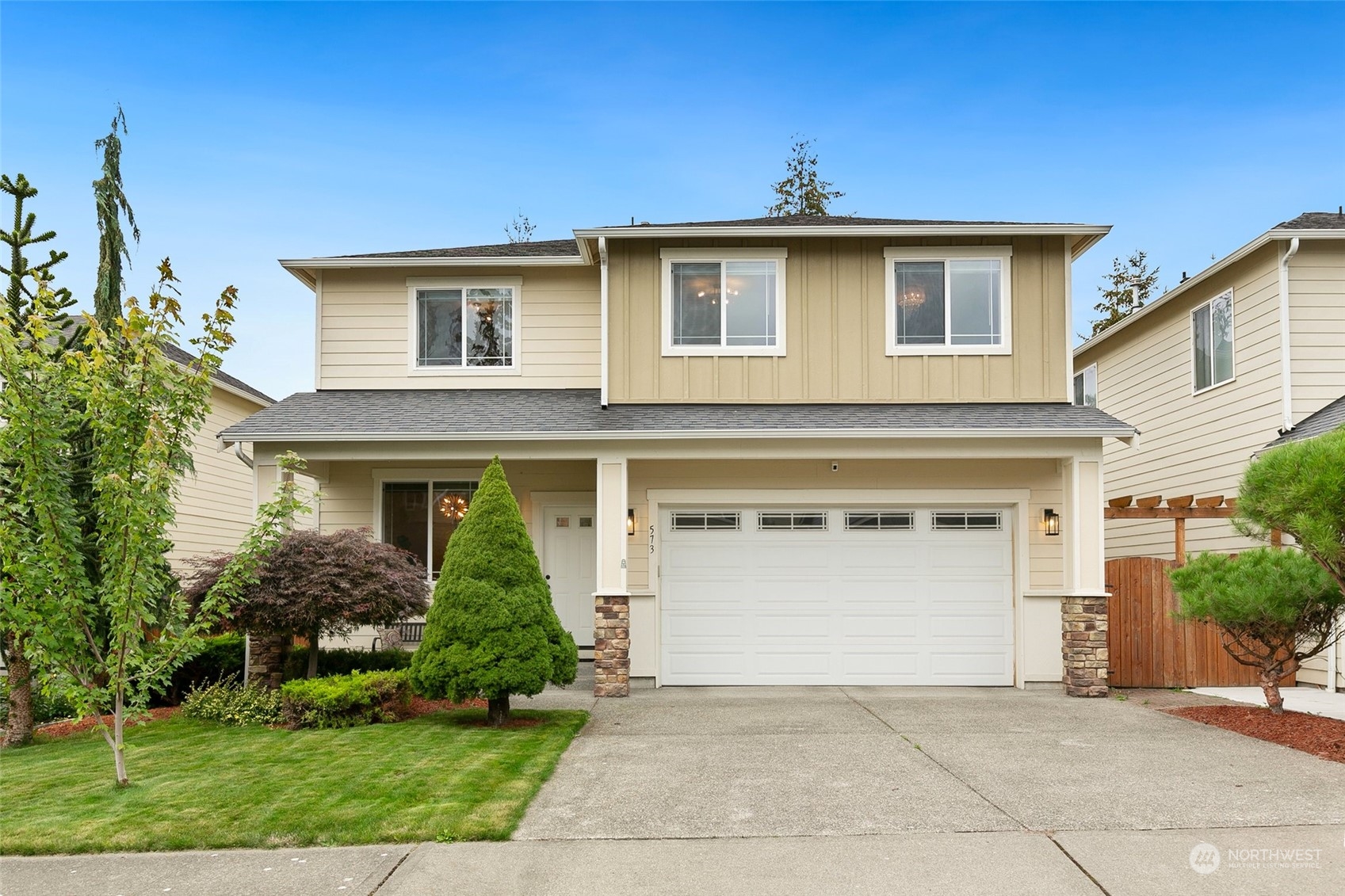 573 Field Place Northeast Renton, WA 98059 - Photo 1 of 34 a front view of a house with garden