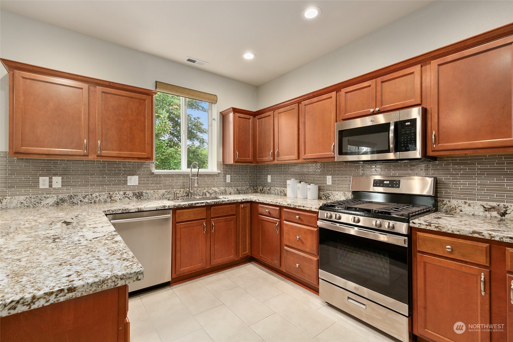 573 Field Place Northeast Renton, WA 98059 - Photo 11 of 34 a kitchen with stainless steel appliances granite countertop wooden cabinets granite counter tops and a window