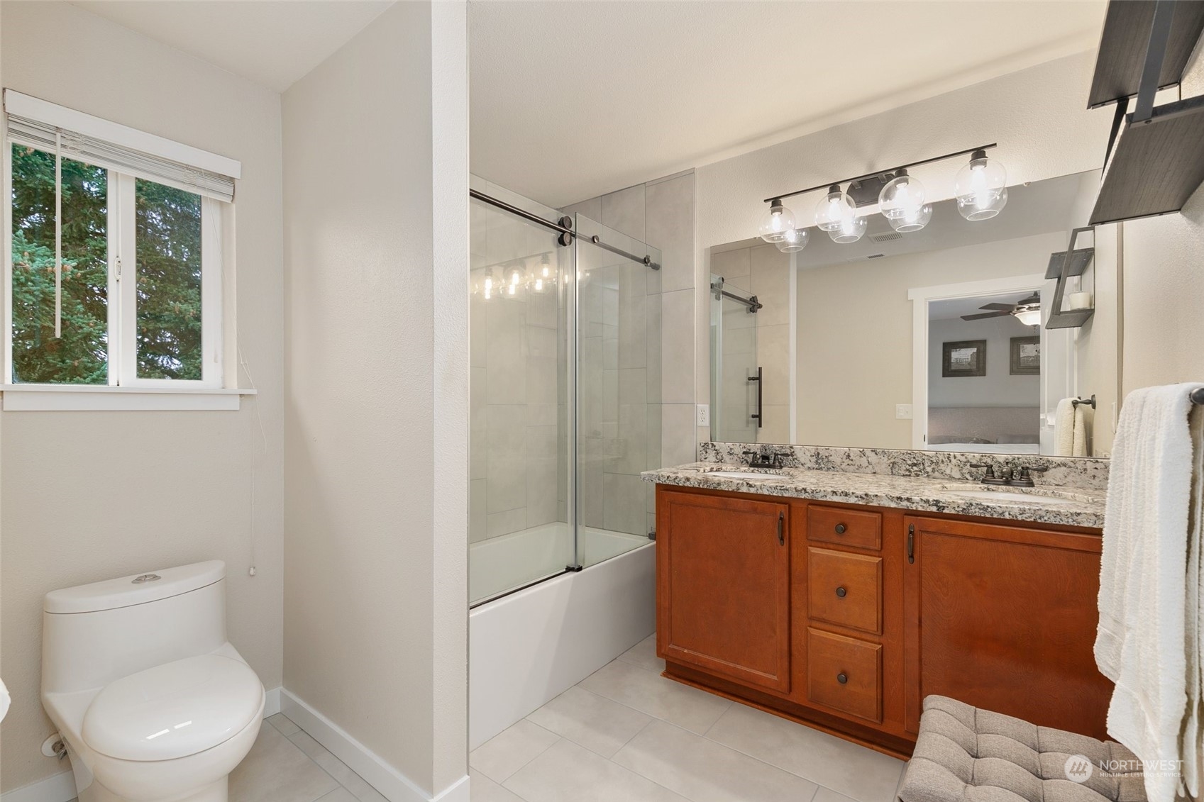 573 Field Place Northeast Renton, WA 98059 - Photo 22 of 34 a bathroom with a granite countertop sink toilet mirror and bathtub