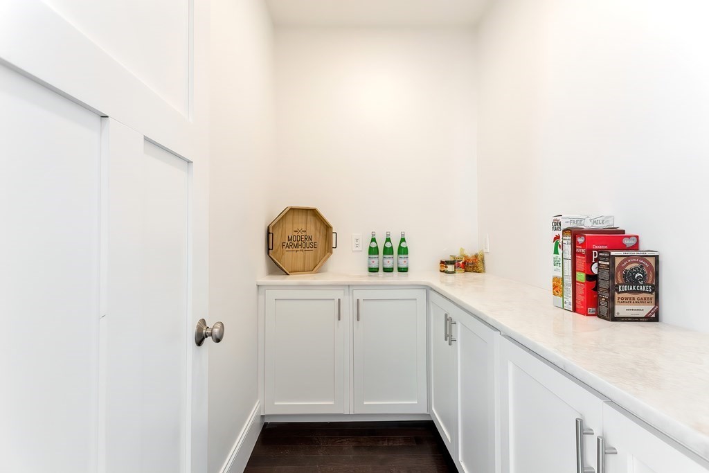 9 Hawthorne Road Lexington, MA 02420 - Photo 13 of 38 a storage room with a sink and wooden floor