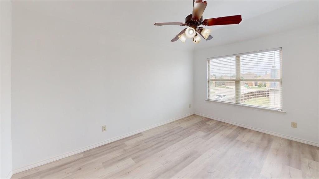 101 Rocky Pine Road McKinney, TX 75072 - Photo 21 of 39 wooden floor in an empty room with a window
