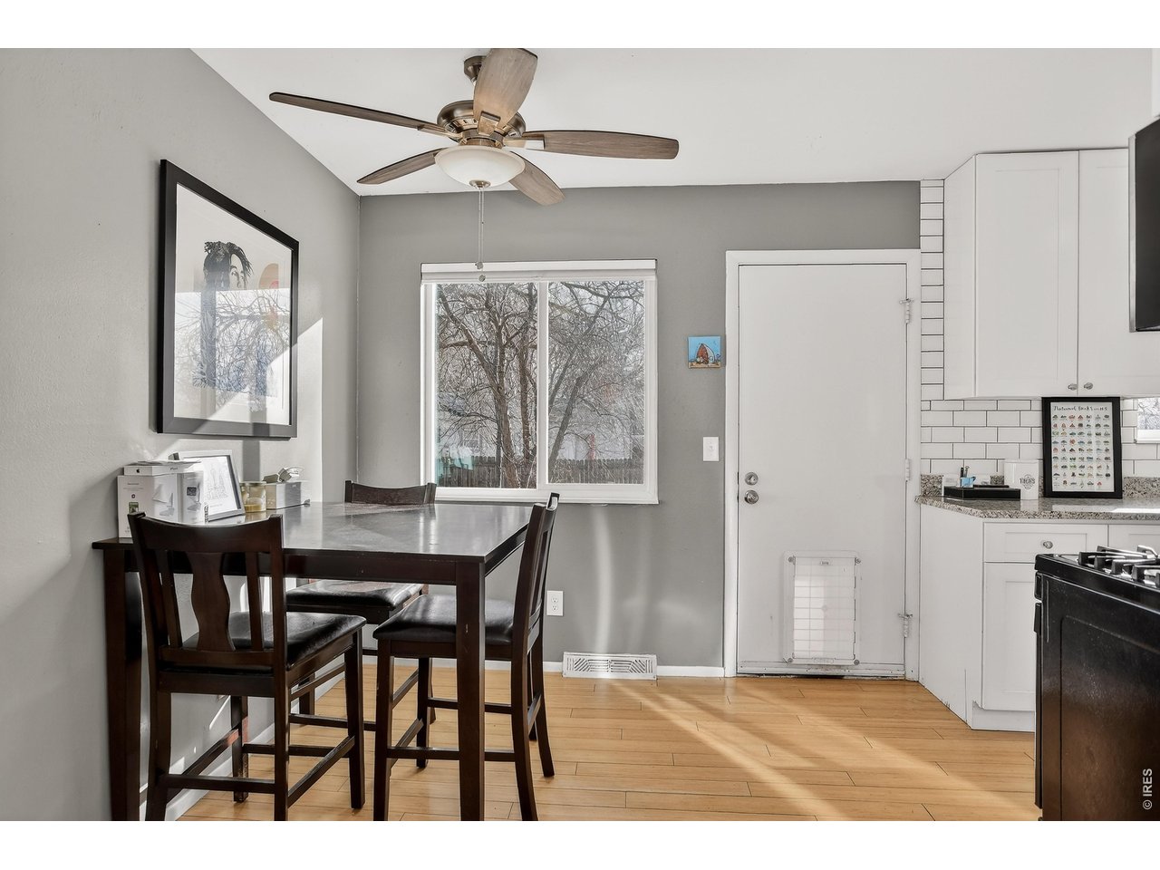 10696 Newcombe Street Westminster, CO 80021 - Photo 13 of 36 a view of a dining room with furniture and a chandelier