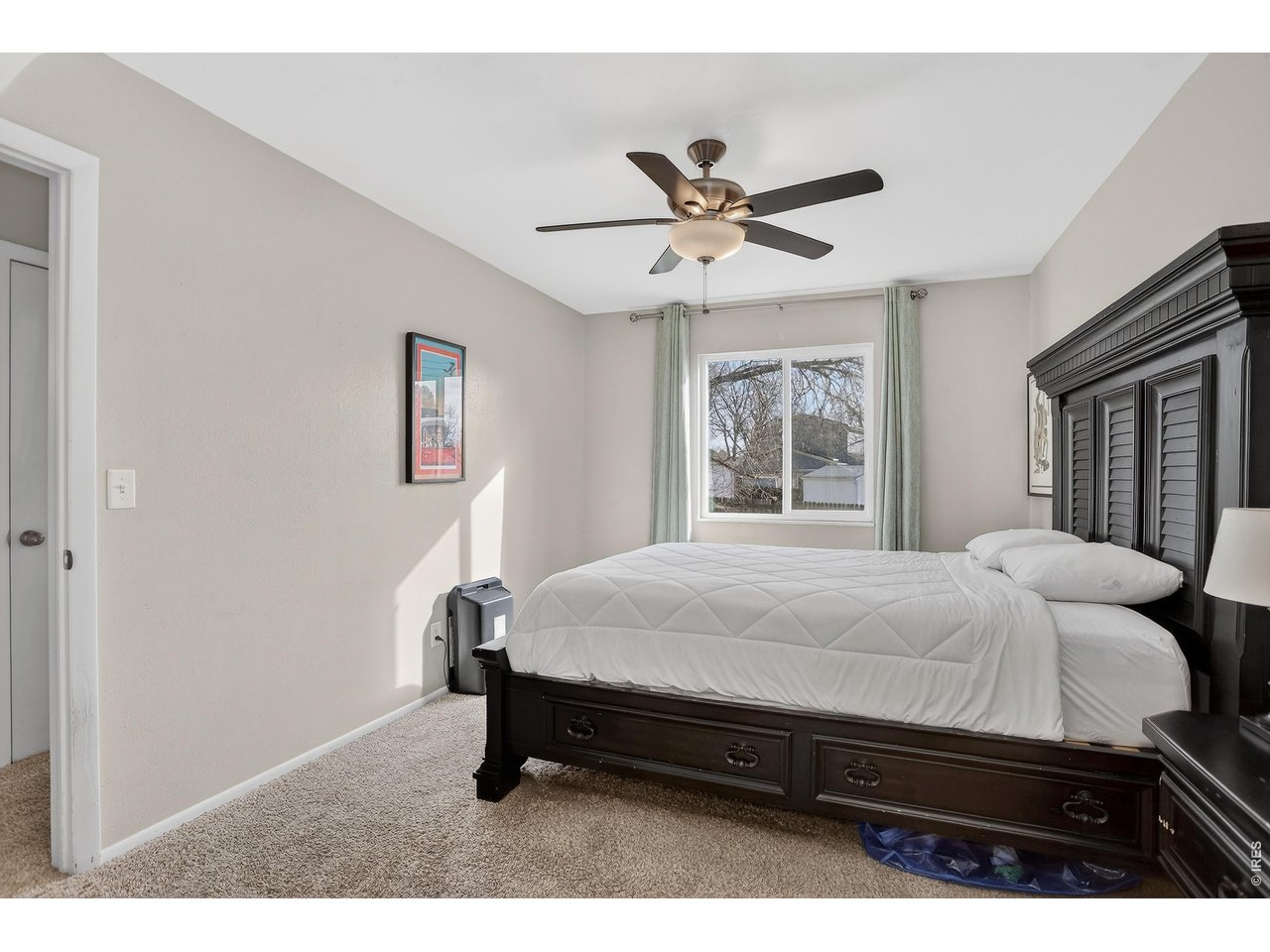 10696 Newcombe Street Westminster, CO 80021 - Photo 16 of 36 a bedroom with a bed and window