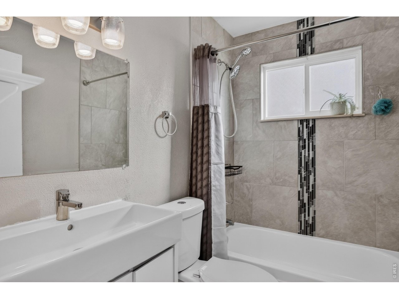 10696 Newcombe Street Westminster, CO 80021 - Photo 19 of 36 a bathroom with a sink and a mirror
