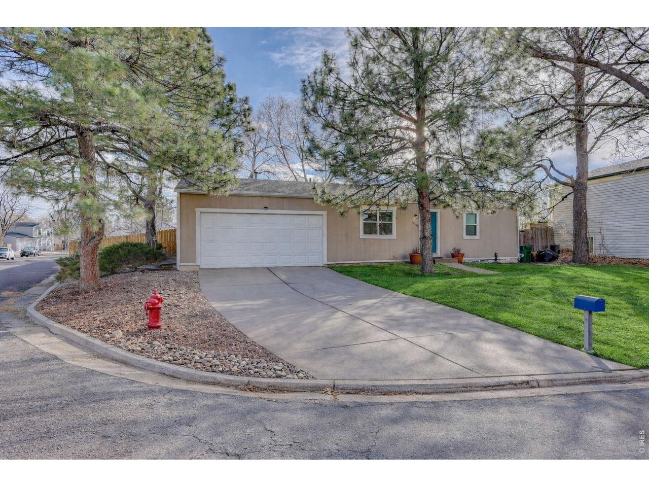 10696 Newcombe Street Westminster, CO 80021 - Photo 2 of 36 a white house with a yard and wooden fence