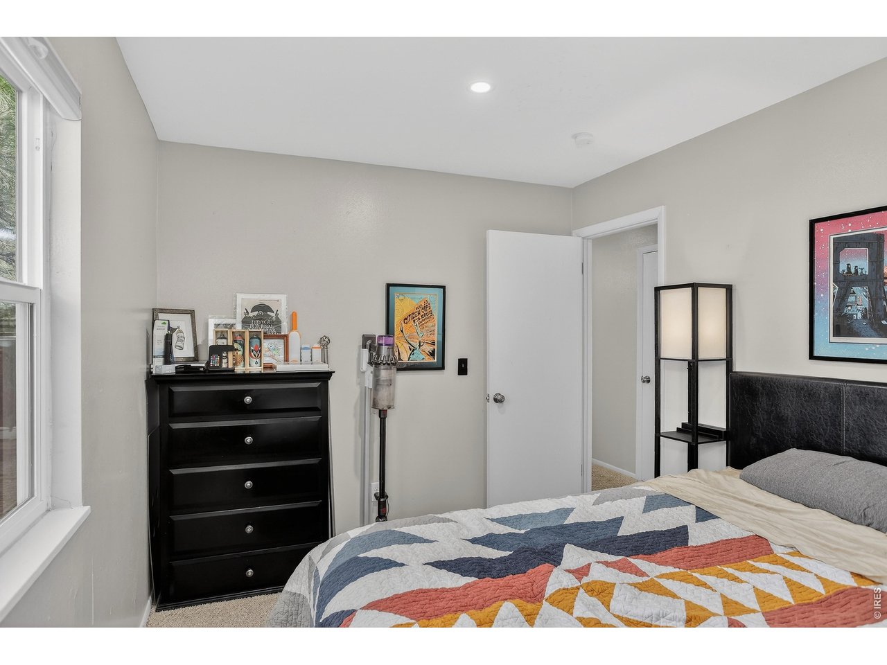 10696 Newcombe Street Westminster, CO 80021 - Photo 22 of 36 a bedroom with a bed and a dresser