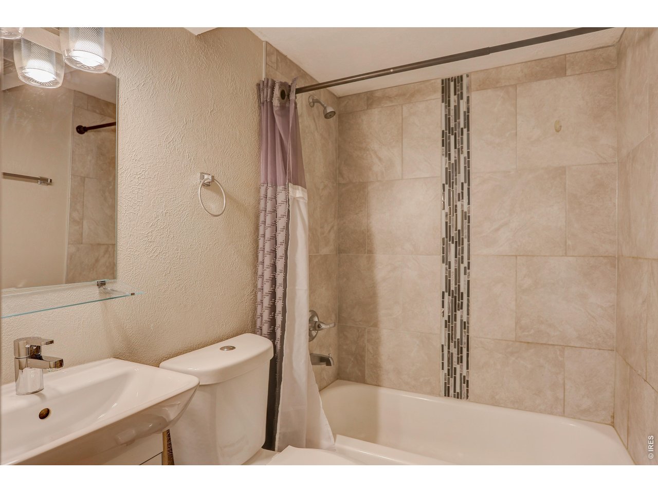 10696 Newcombe Street Westminster, CO 80021 - Photo 27 of 36 a bathroom with a sink a toilet and shower