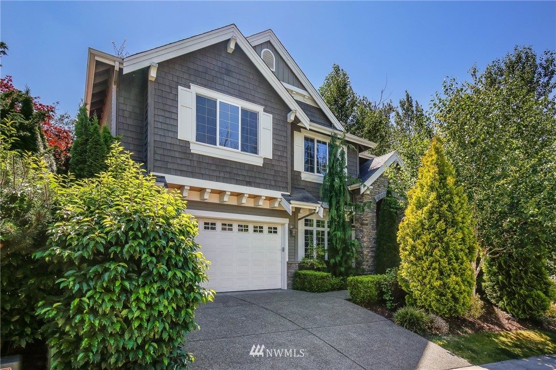 807 South 36th Place Renton, WA 98055 - Photo 1 of 39 a view of a house with plants and covered with trees