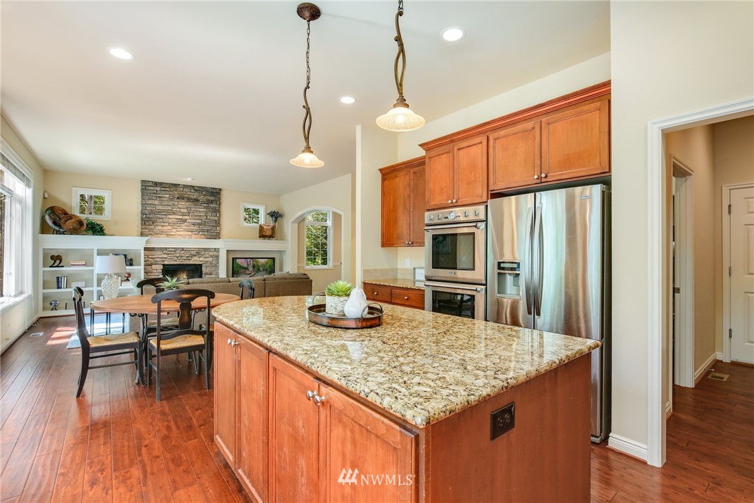 807 South 36th Place Renton, WA 98055 - Photo 11 of 39 a kitchen with stainless steel appliances granite countertop a stove kitchen island a refrigerator and a kitchen island