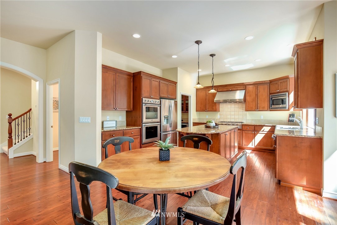 807 South 36th Place Renton, WA 98055 - Photo 14 of 39 a view of a dining room with furniture window and wooden floor