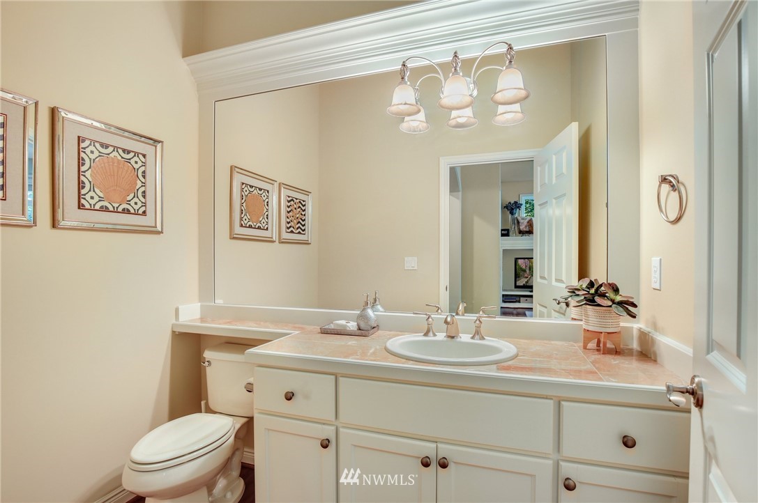 807 South 36th Place Renton, WA 98055 - Photo 19 of 39 a bathroom with a toilet a sink a mirror a and a shower