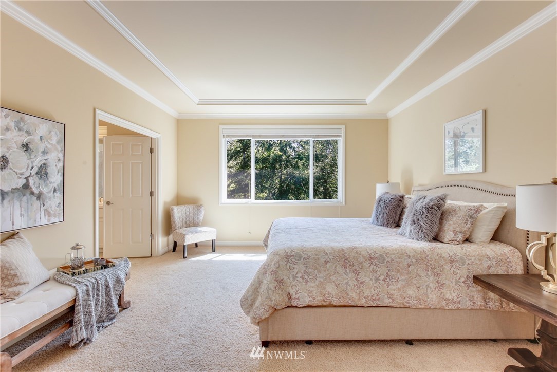 807 South 36th Place Renton, WA 98055 - Photo 24 of 39 a bedroom with a large bed couch and a window