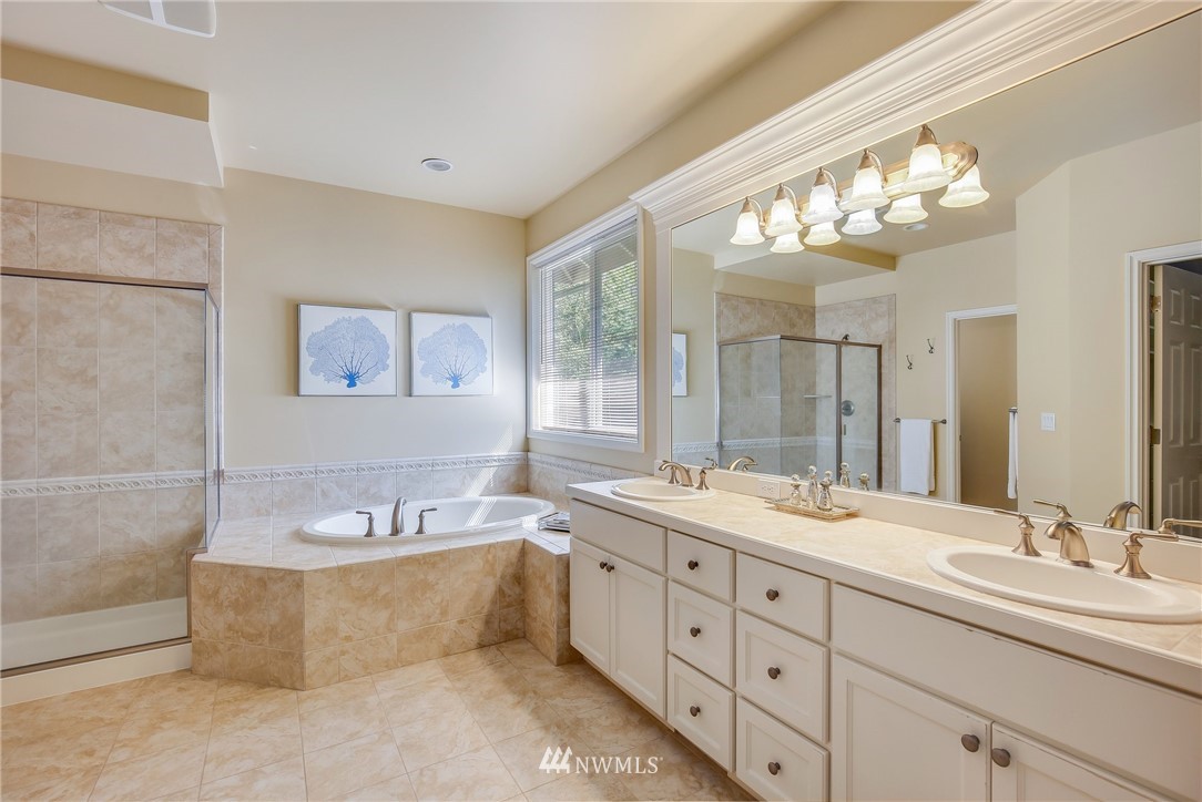 807 South 36th Place Renton, WA 98055 - Photo 26 of 39 a bathroom with a tub double sink and mirror