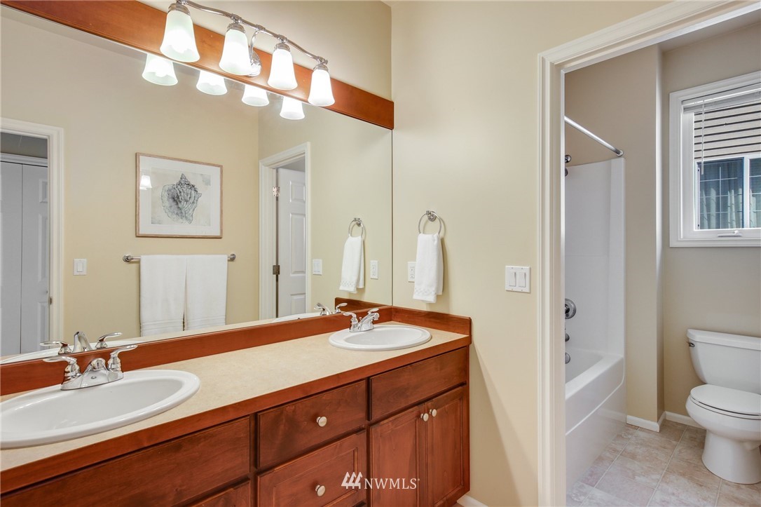 807 South 36th Place Renton, WA 98055 - Photo 34 of 39 a bathroom with a granite countertop sink and a mirror