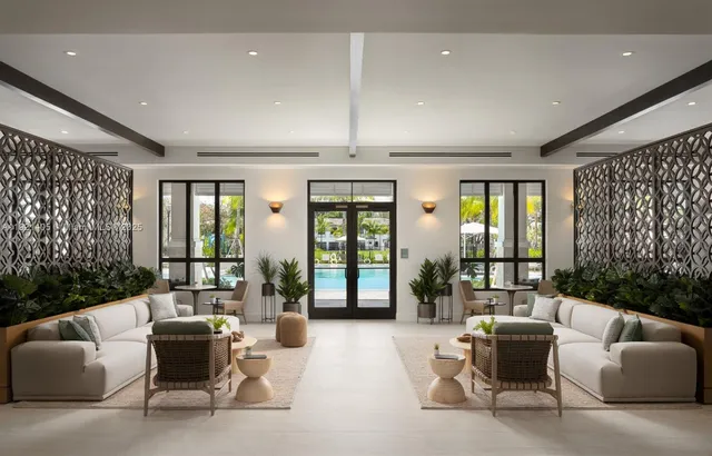 a living room with furniture and large windows