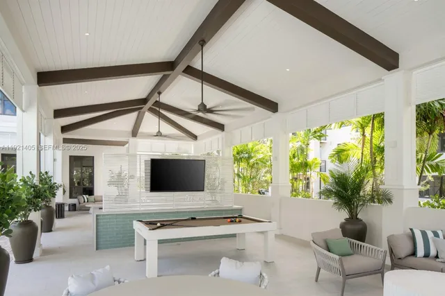 a living room with furniture tv and a large window