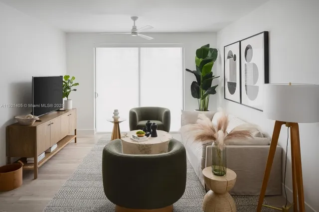 a living room with furniture and a potted plant