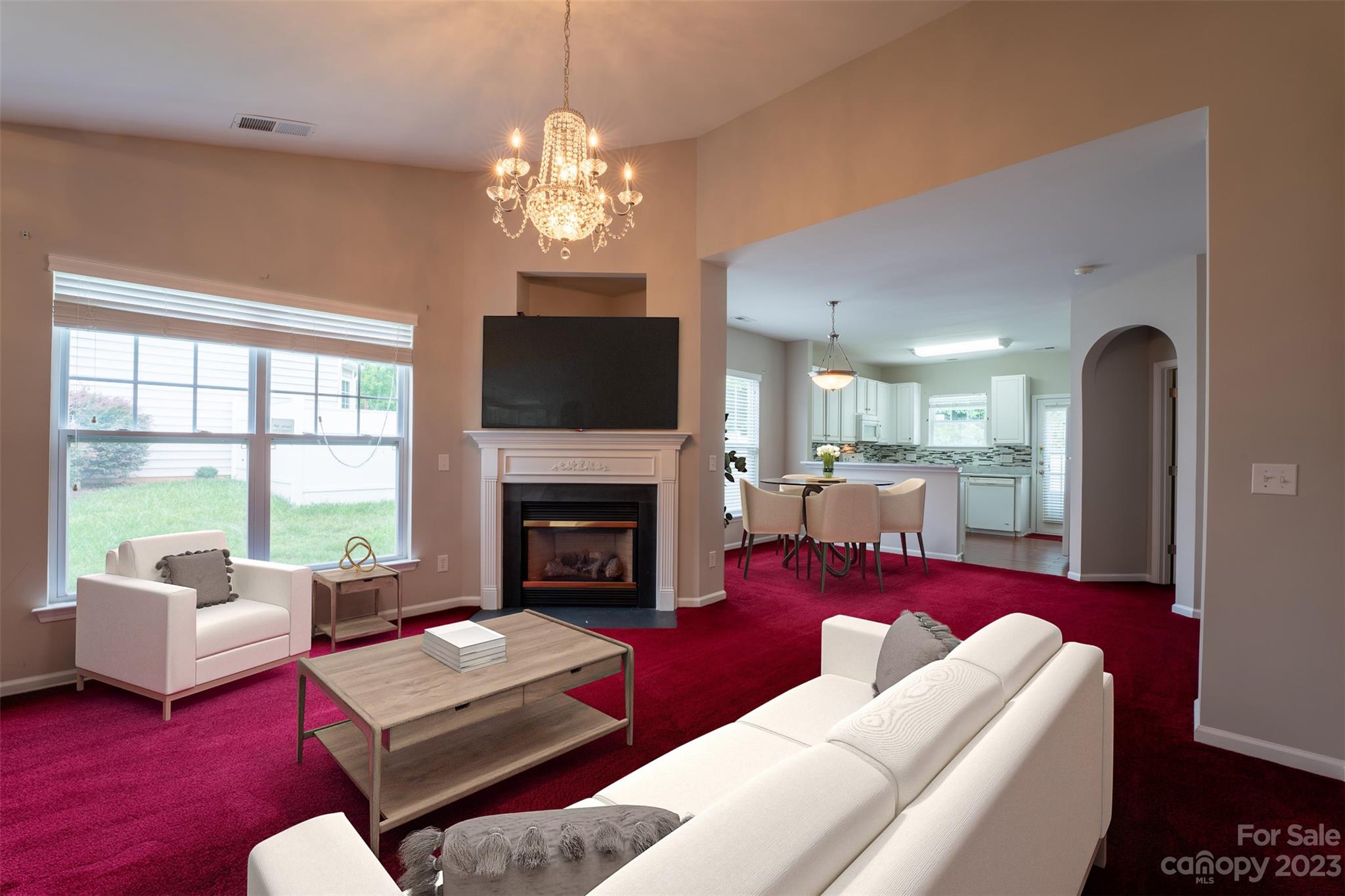 143 Whitley Mills Road Fort Mill, SC 29708 - Photo 14 of 28 a living room with furniture a chandelier and a fireplace