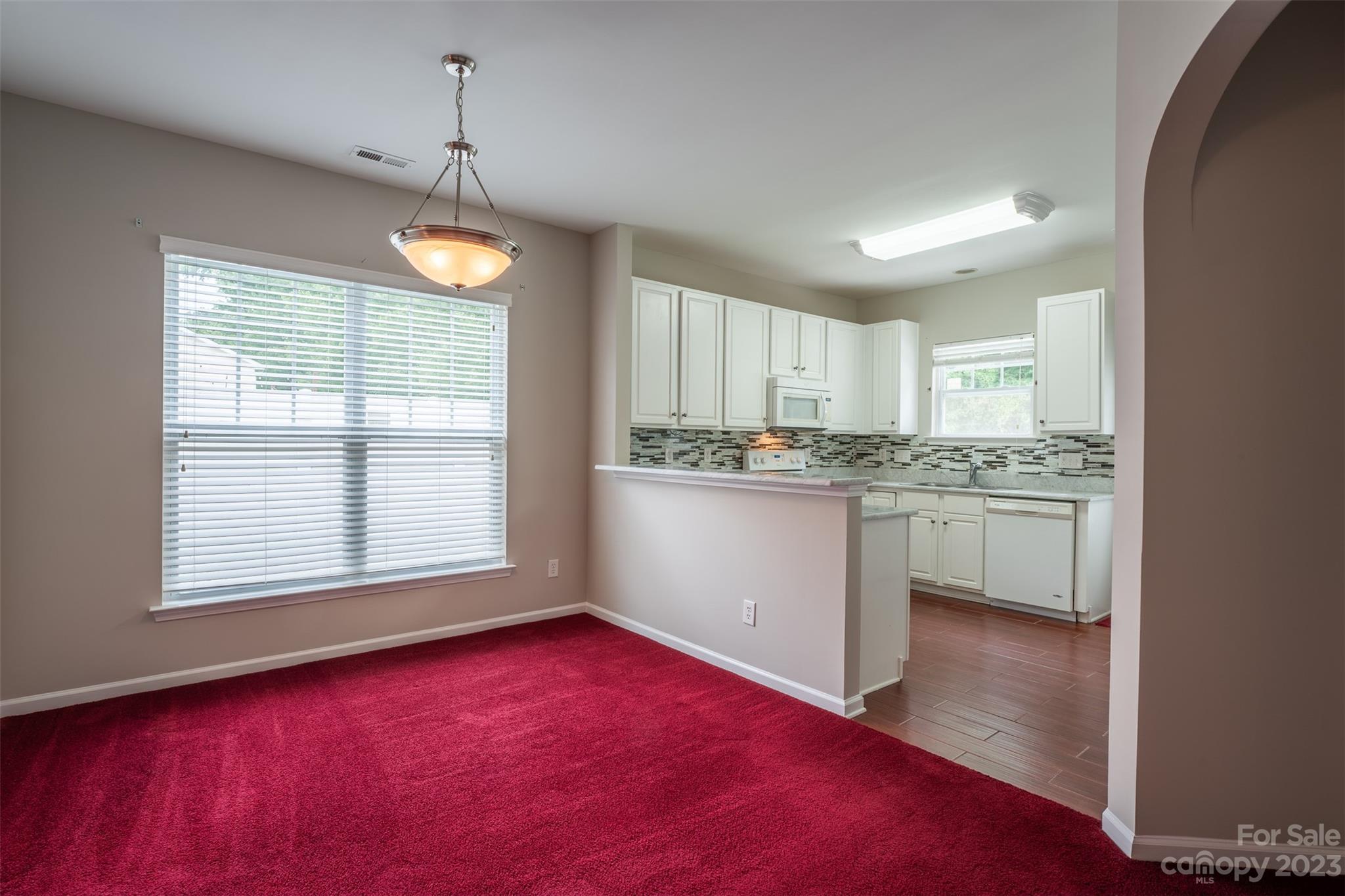 143 Whitley Mills Road Fort Mill, SC 29708 - Photo 16 of 28 a kitchen with stainless steel appliances granite countertop a stove a sink dishwasher a refrigerator and white cabinets with wooden floor