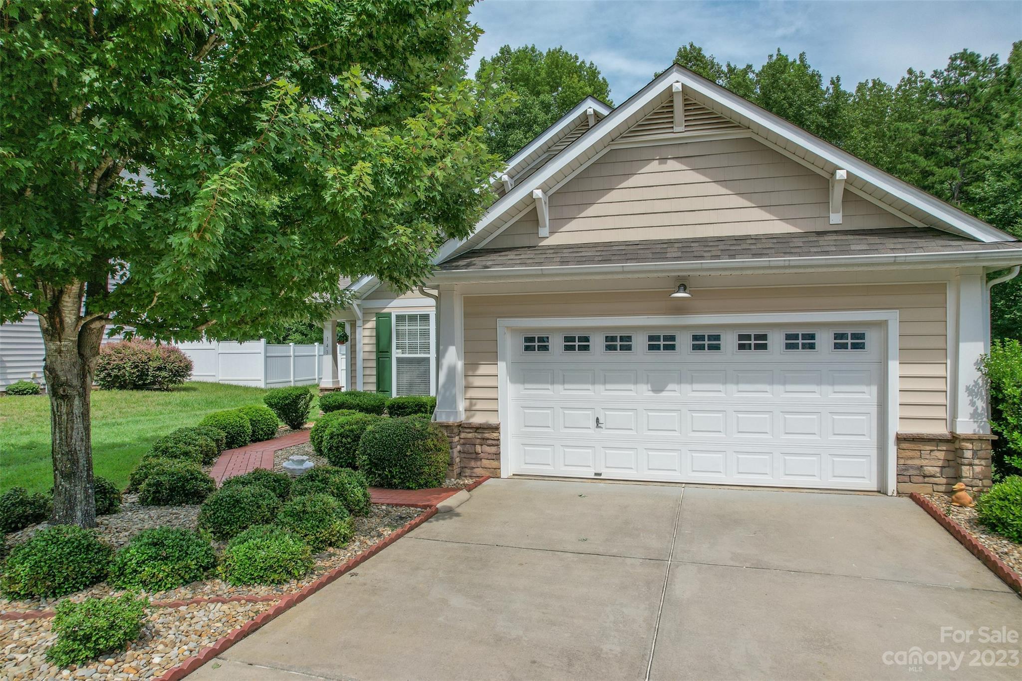 143 Whitley Mills Road Fort Mill, SC 29708 - Photo 2 of 28 a front view of a house with a yard and garage