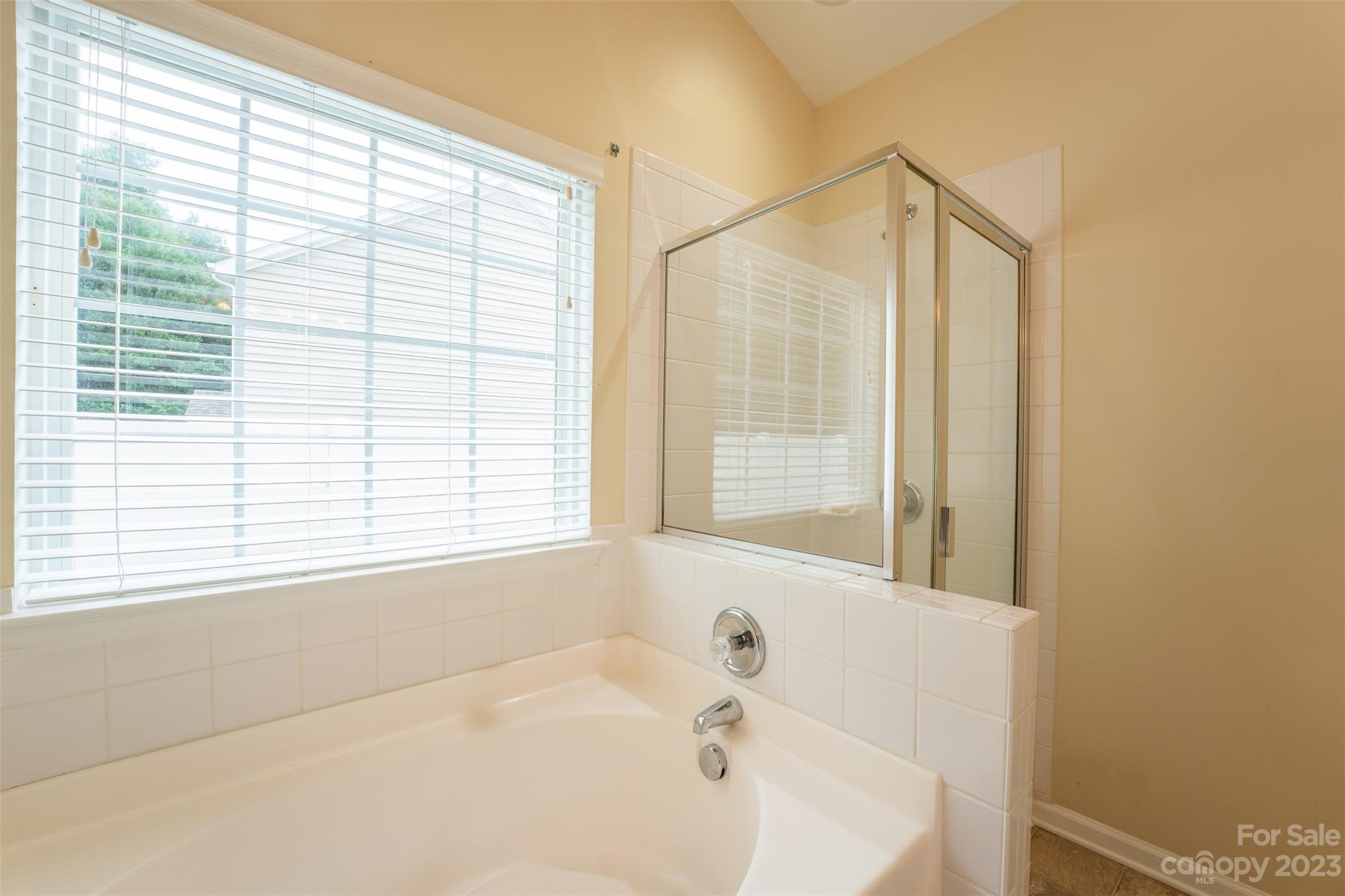 143 Whitley Mills Road Fort Mill, SC 29708 - Photo 21 of 28 a bathroom with a bathtub and a window