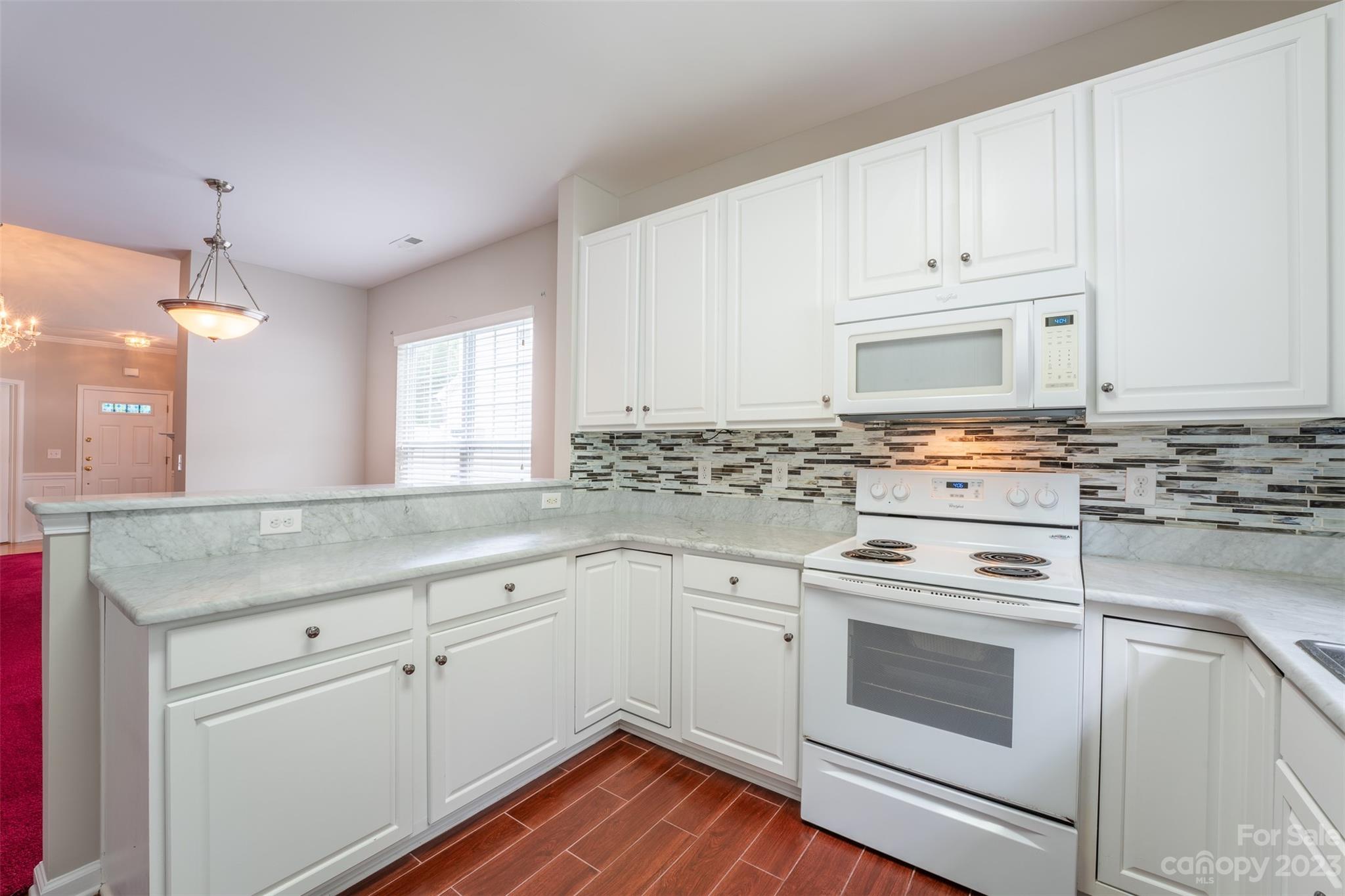 143 Whitley Mills Road Fort Mill, SC 29708 - Photo 4 of 28 a kitchen with granite countertop white cabinets and white appliances