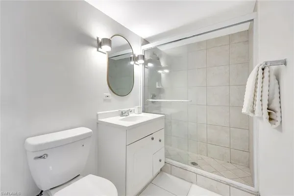 a bathroom with a toilet sink and shower