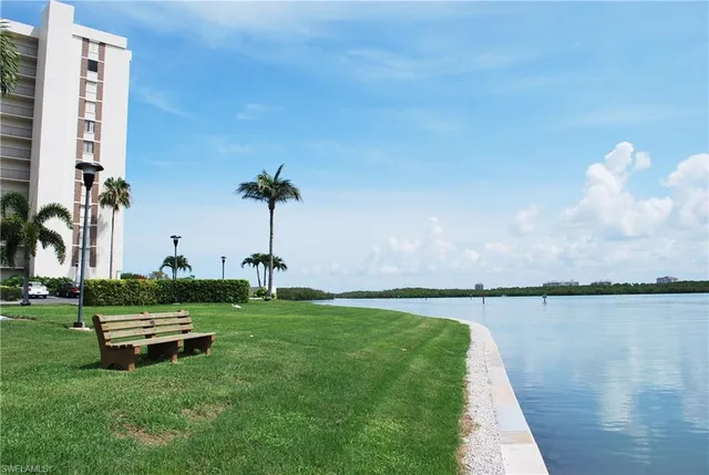 a view of a lake with a bench in the background